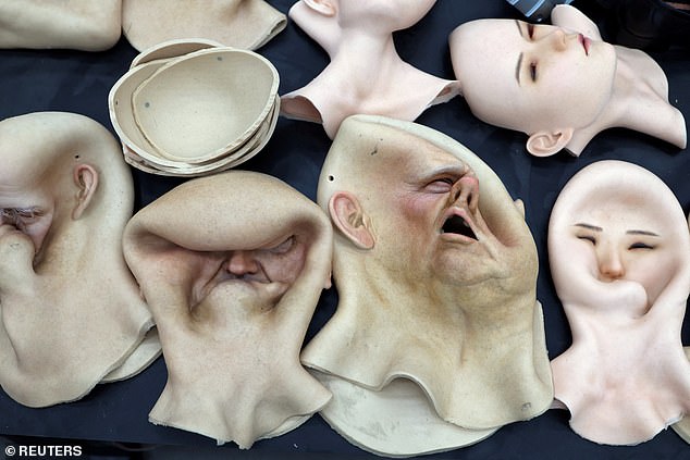 Heads for humanoid robots lie on a table at the Ex-Robots factory in Liaoning province, China