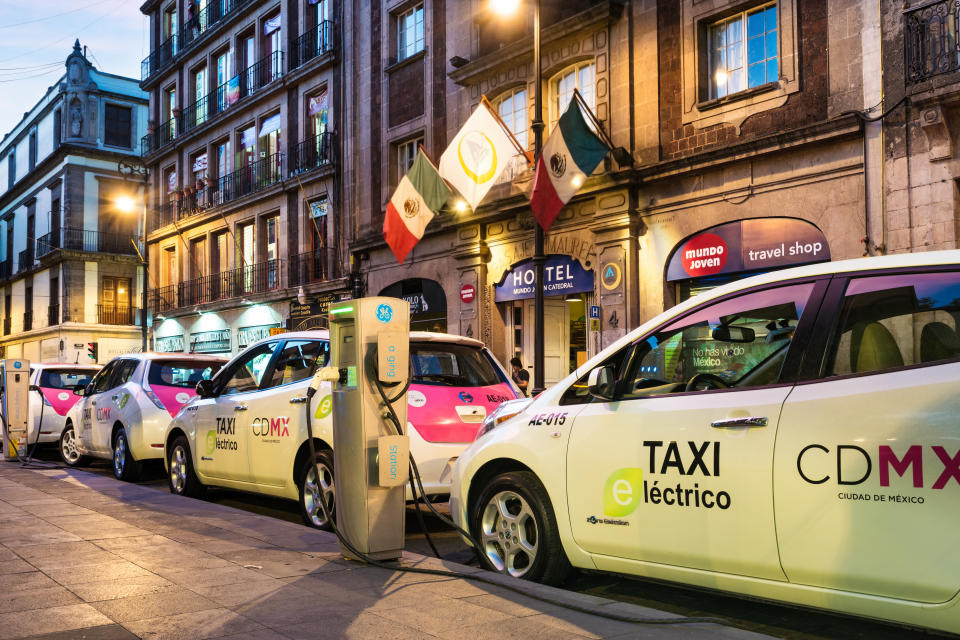 Electric taxis are being charged at a charging station in downtown Mexico City, Mexico at night.