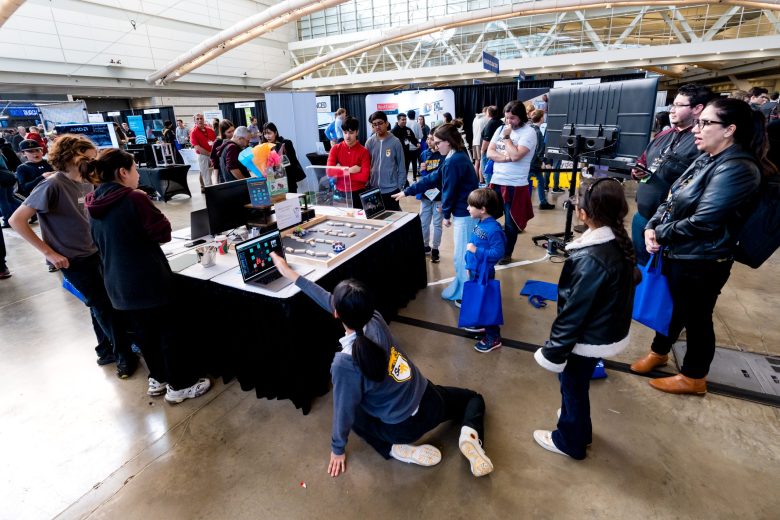 Kids play with the cute bot at Discovery Day.