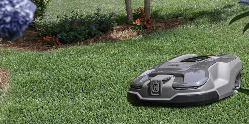 The Husqvarna Automower 415X Robotic Lawn Mower mowing a lawn.