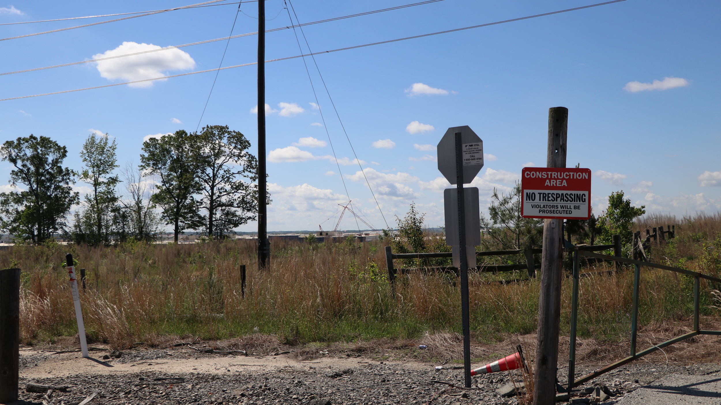 Cranes can be seen in the distance from a gravel road in Liberty, indicating that construction is well underway on the plant that is scheduled to begin production in 2025. Credit: Nicole Norman/Medill News Service