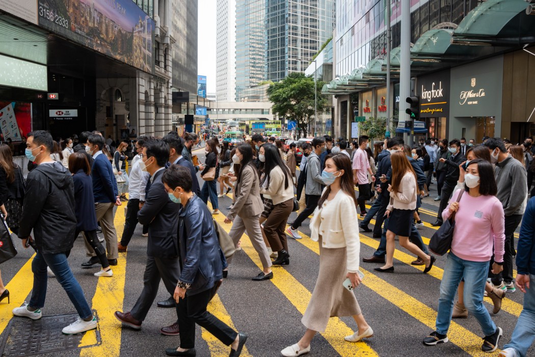 People cross the street in Central, Hong Kong, on February 13, 2023. Photo: Kyle Lam/HKFP.