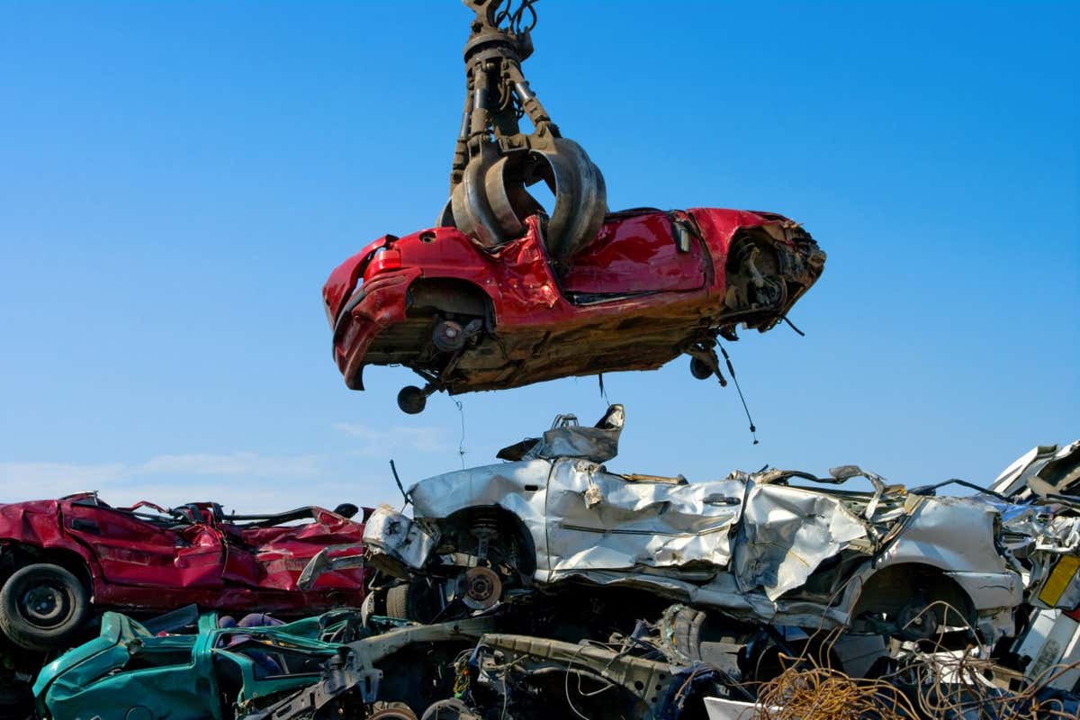 Crane picking up a car in a junkyard; Shutterstock ID 36444292; purchase_order: -; job: -; client: -; other: -