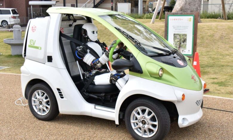 Watch a humanoid robot driving a car extremely slowly Watch a humanoid robot driving a car extremely slowly