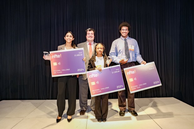 Ariana Whitaker, center, holds her 1st place award while standing with, from left, 2nd place winner, Raahi Pachbhai of St. Louis Science Center in Missouri, NFTE CEO J.D. LaRock and 3rd place winner Tywon Barber from Beloit Memorial High School in Wisconsin. (NFTE/Carasco Photography)