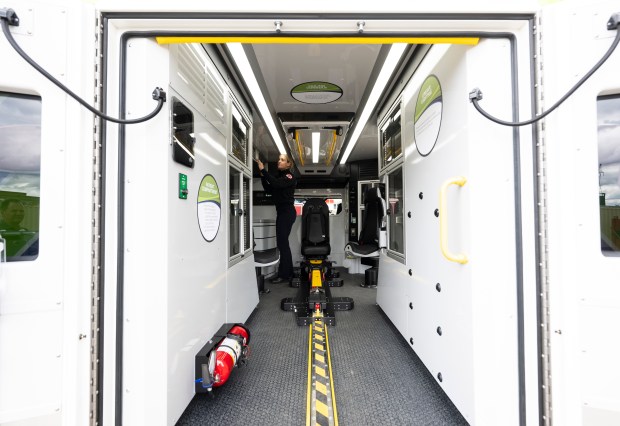 A St Paul firefighter looks over an electric ambulance.