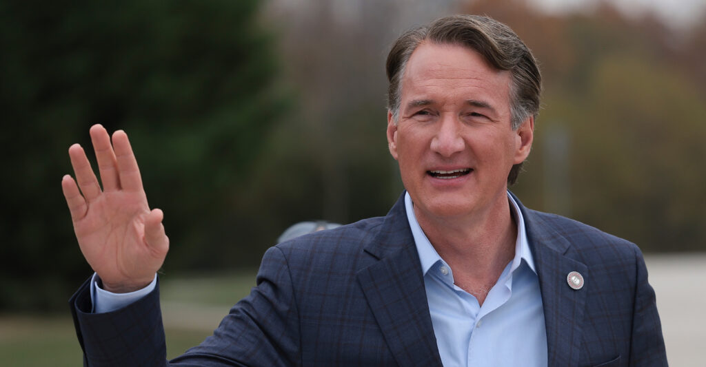 Virginia Gov. Glenn Youngkin waving his hand.