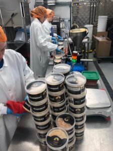 Workers prepare Oasis hummus at Kalona Direct. The off-site operation began in 2020. CREDIT OASIS