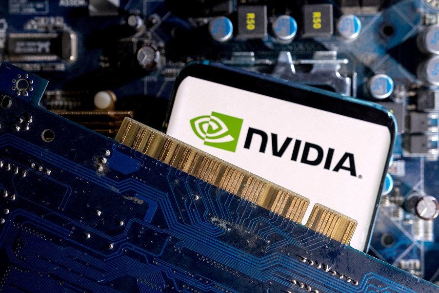 A smartphone with a displayed NVIDIA logo is placed on a computer motherboard in this illustration taken 6 March 2023. (Dado Ruvic/Reuters)