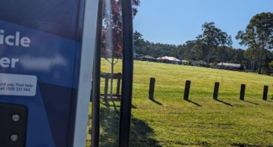 EV charger (right) next to a field (left).