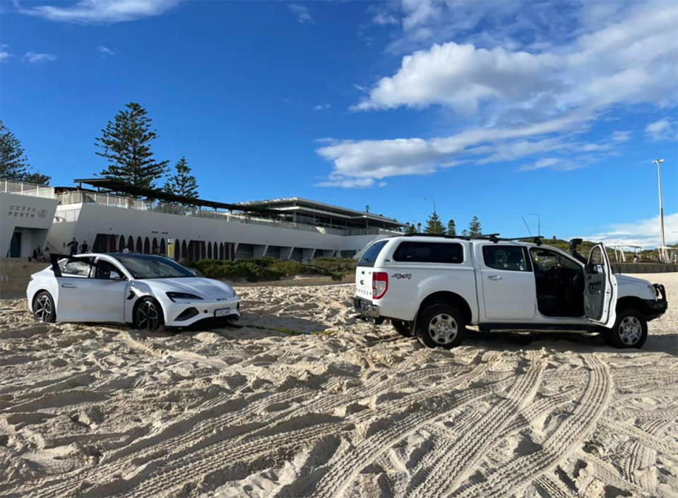 A BYD being pulled out by a 4WD on Perth's City beach.