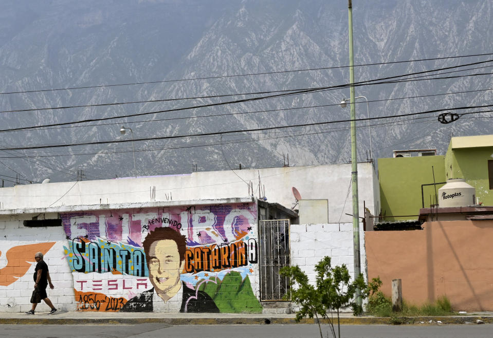 A man walks past a mural depicting SpaceX, X and electric car maker Tesla CEO Elon Musk in Santa Catarina, Nuevo Leon state, Mexico on April 29, 2024. Sparks fly as a laser slices through metal in a factory in Mexico, which is preparing for a new wave of foreign investment thanks to heightened tensions between the United States and China. Geopolitical frictions and supply chain gridlock during the Covid pandemic have prompted a growing number of companies to move manufacturing operations to the doorstep of the world's biggest economy. (Photo by ALFREDO ESTRELLA / AFP) (Photo by ALFREDO ESTRELLA/AFP via Getty Images)