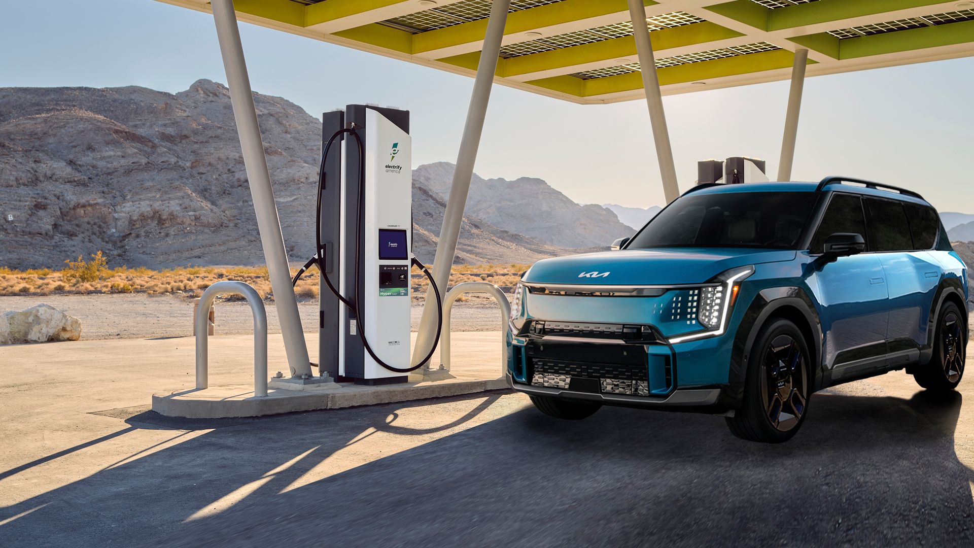 Photo of a Kia EV9 charging at an Electrify America charging station