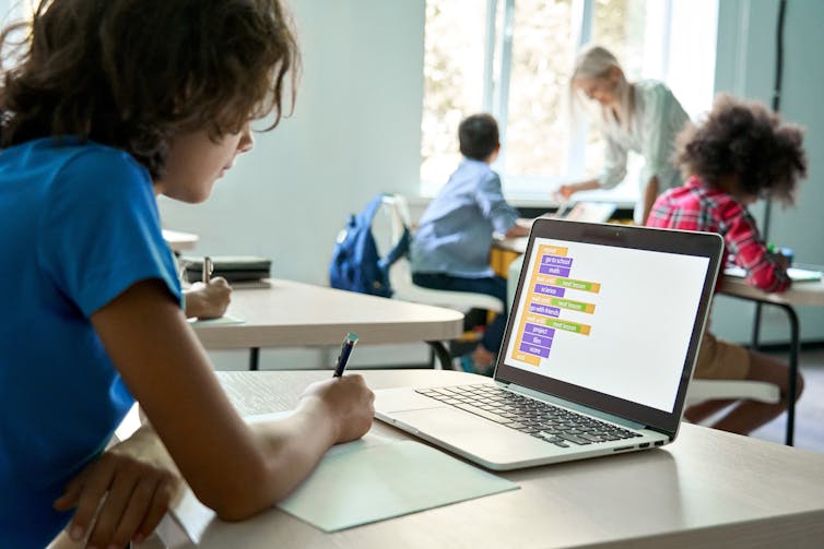 A school pupil looking at a laptop screen in class.