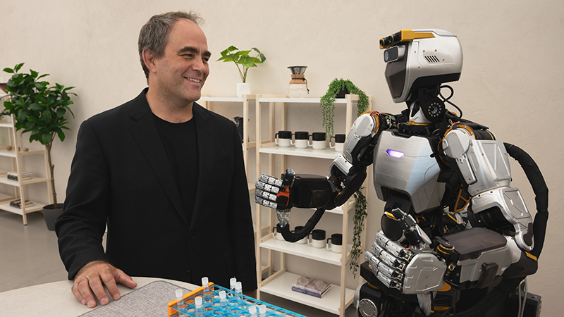 Sanctuary AI co-founder and CEO Geordie Rose with the Phoenix humanoid robot