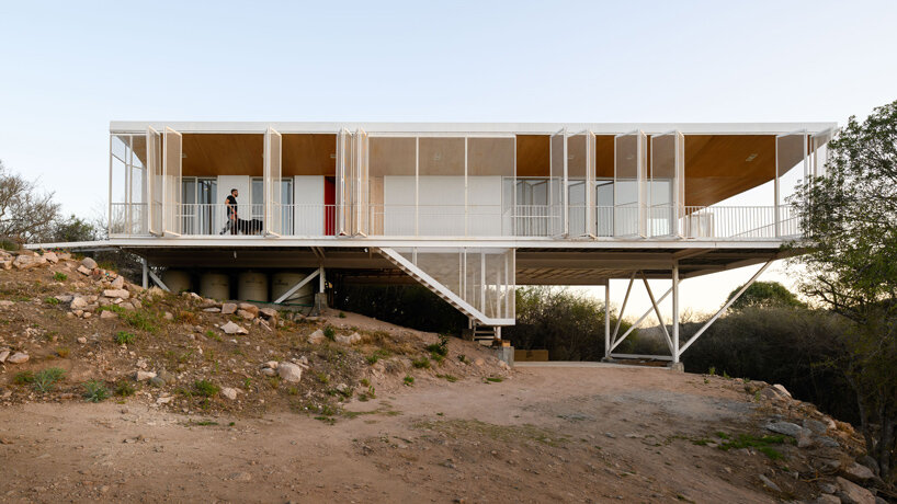 zayat arquitectura encases 'house in the clouds' with perforated panels in argentina