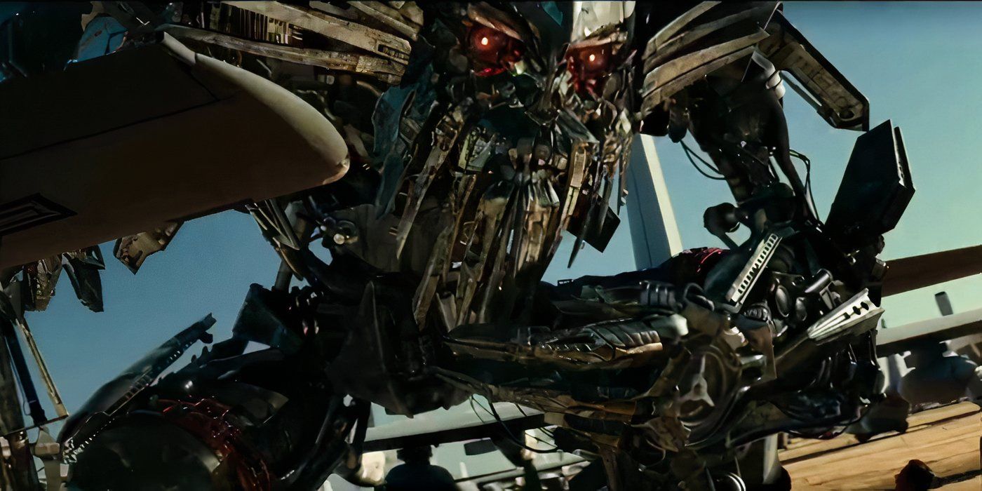 Jetfire kneeling over some humans in Transformers: Revenge of the Fallen