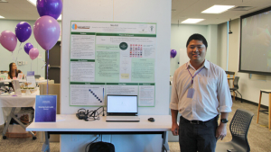 person standing in front of a large presentation poster