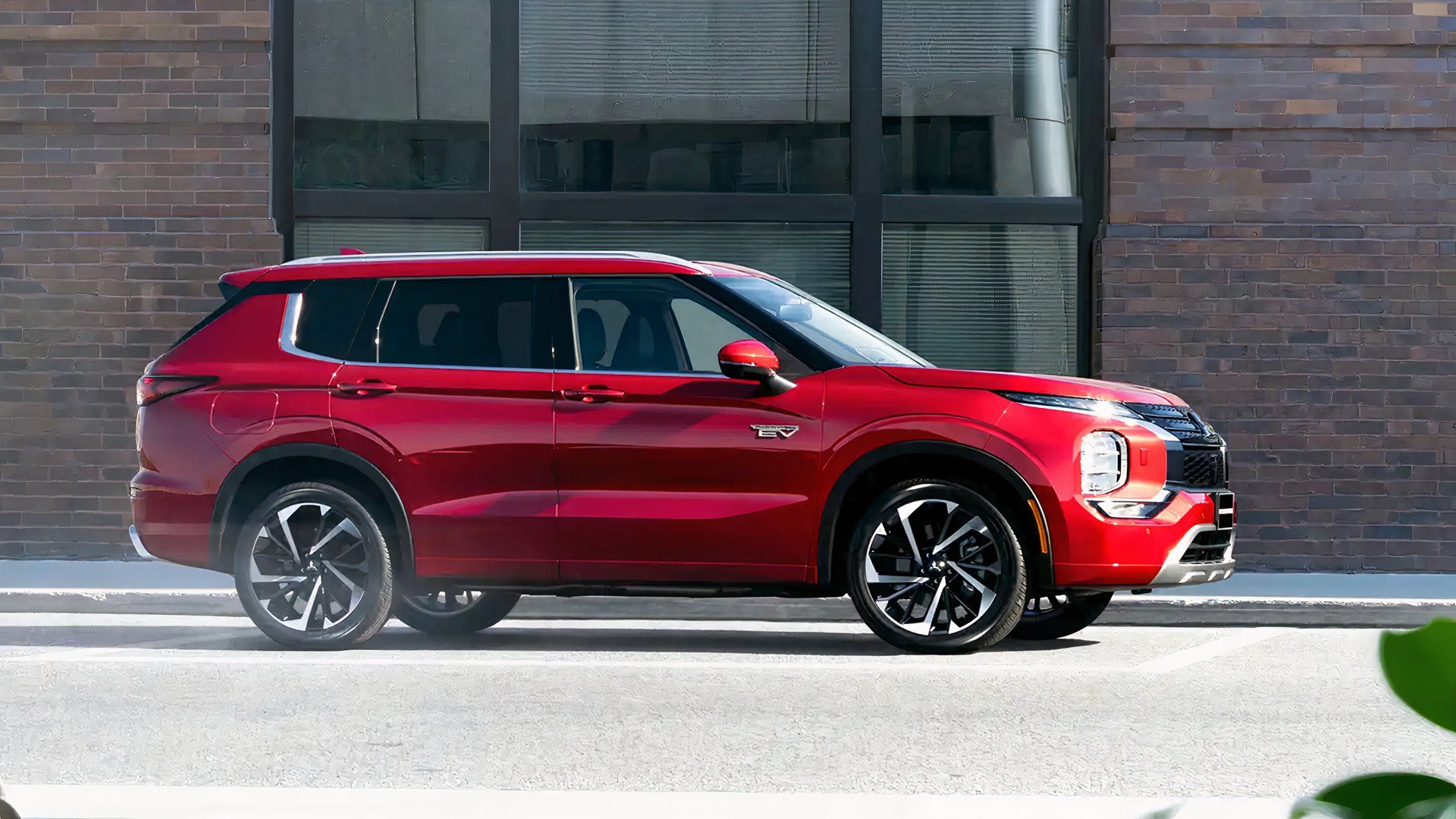 Side profile shot of a red Mitsubishi Outlander PHEV