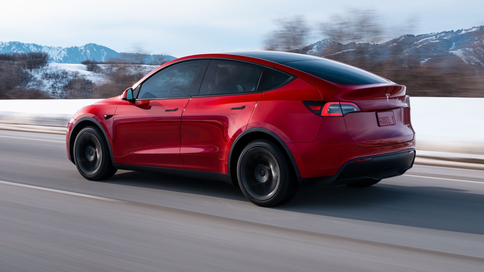 Red Tesla Model Y rear-quarter